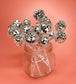 Party table setup with shimmering retro disco ball stir sticks